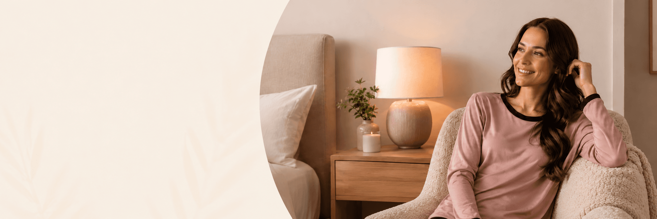 Woman in pink SoftConnection loungewear relaxing in a warmly-lit bedroom